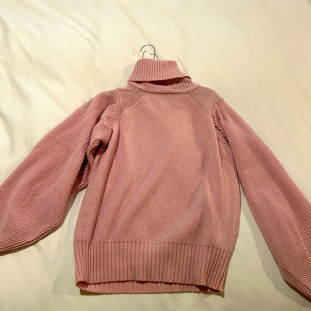 Pink turtleneck sweater from Intermix